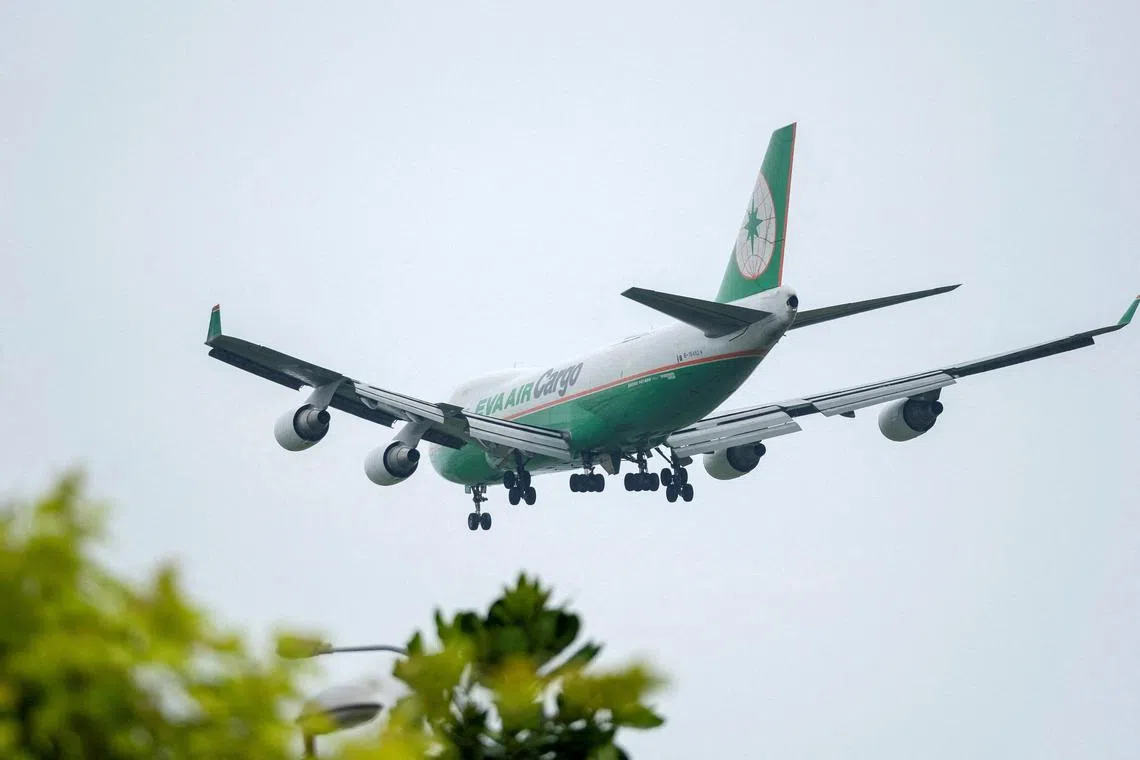 FILE PHOTO: An Eva Air Cargo Boeing 747-400F freighter airplane approaches to land at Changi International Airport in Singapore June 10, 2018.  REUTERS/Tim Chong/File Photo