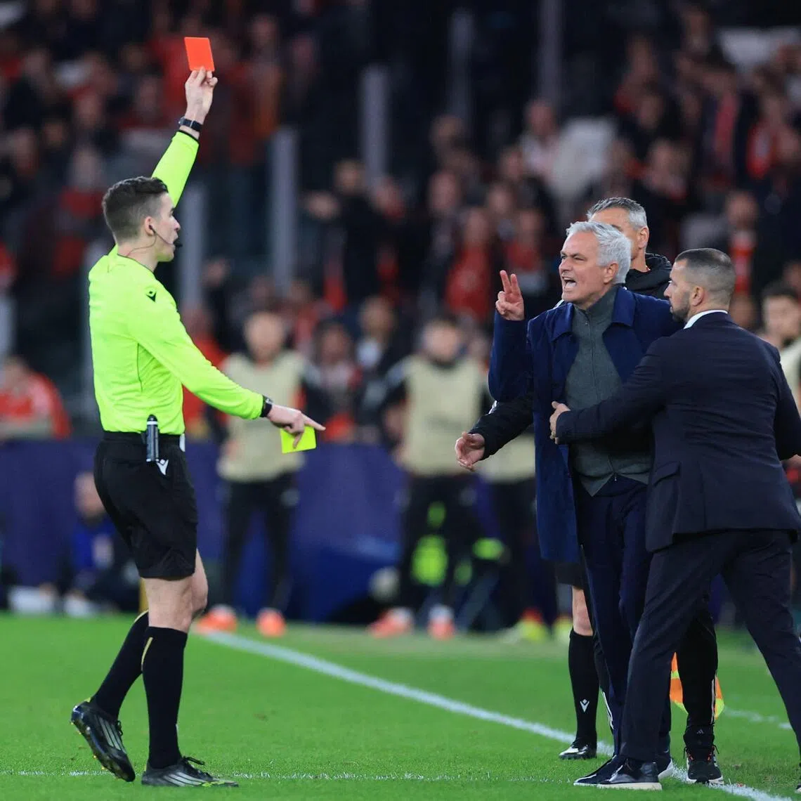 French referee Francois Letexier shows a red card to Benfica coach Jose Mourinho during the Champions League play-off, first leg against Real Madrid.
