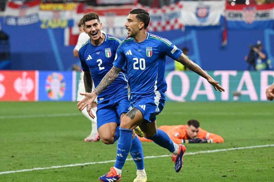 Italy's Mattia Zaccagni (right) celebrates scoring a 98th-minute equaliser that will likely eliminate Croatia from Group B.