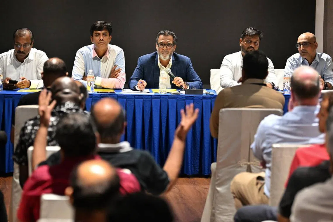 Mahmood Gaznavi, president of the Singapore Cricket Association (facing camera, centre) fielding questions from the floor at the annual general meeting on Friday.