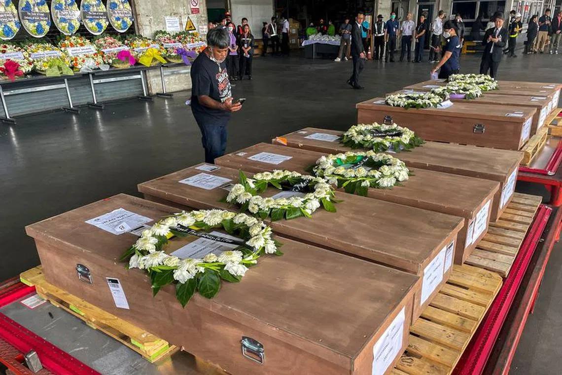 FILE PHOTO: Coffins carrying bodies of Thai migrant agricultural workers who were killed in an attack by the Palestinian militant group Hamas on Israel, arrive at Bangkok's Suvarnabhumi Airport, Thailand, October 20, 2023. REUTERS/Artorn Pookasook/File Photo
