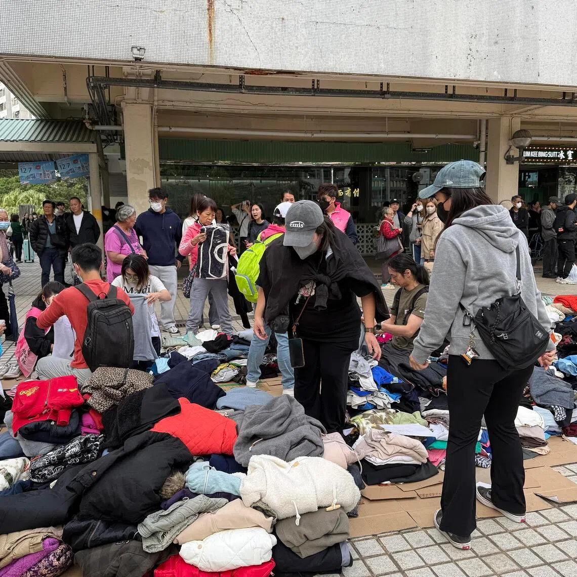 Volunteers gather to help distribute warm clothing at the nearby Kwong Fuk Estate.