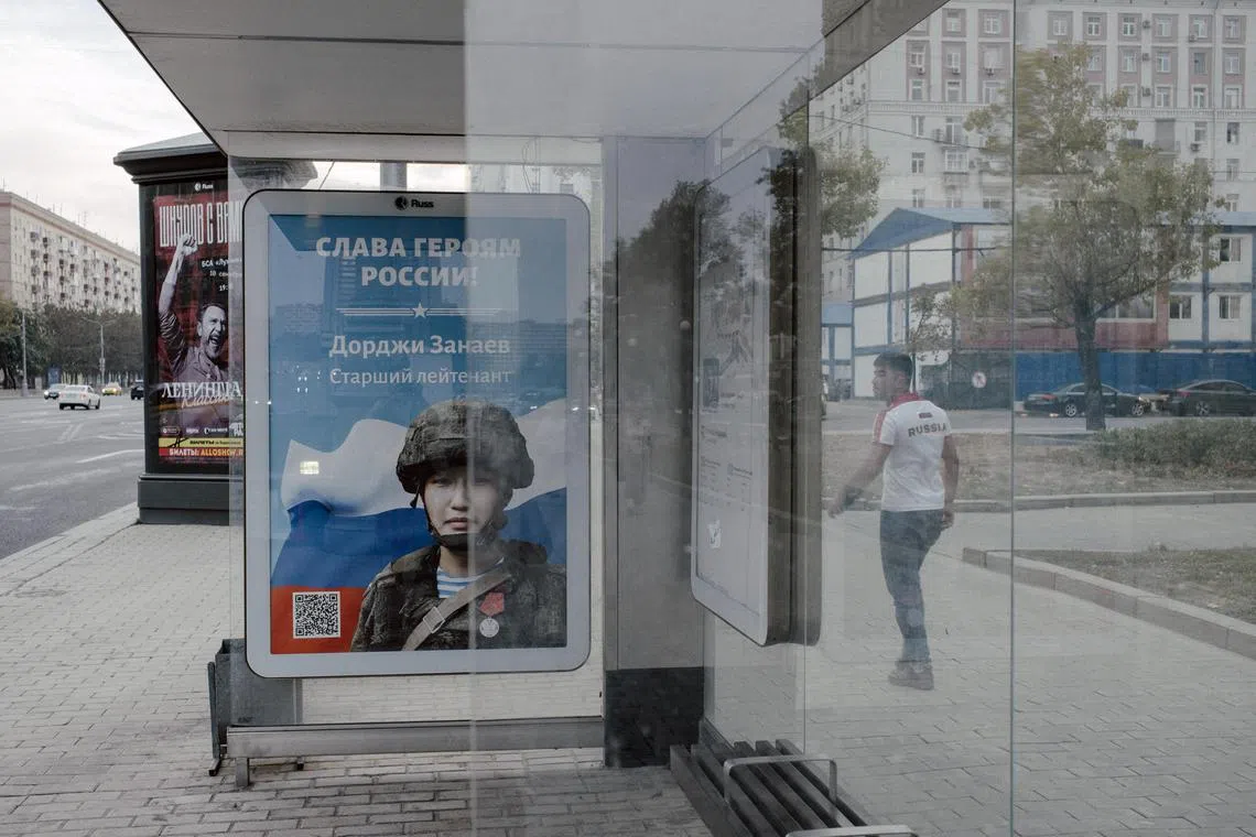 A military recruitment poster at a bus stop in Moscow.