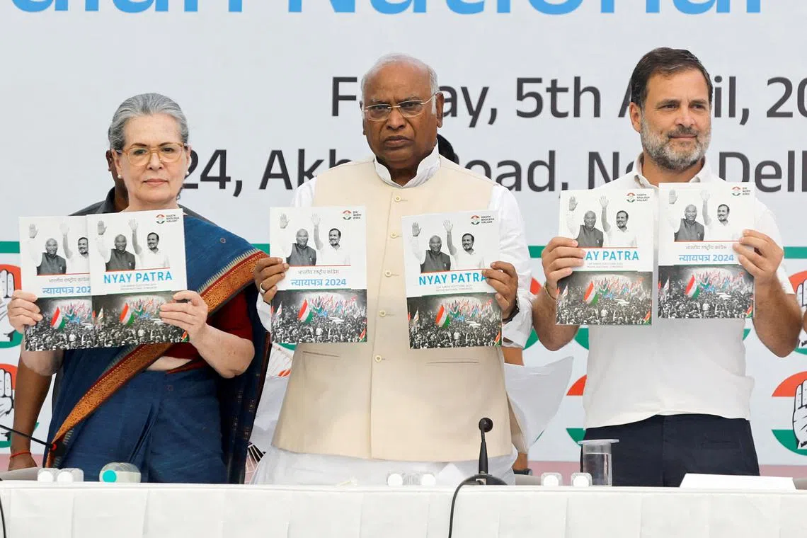 Senior leaders of India's main opposition Congress Party Sonia Gandhi and Rahul Gandhi, along with Mallikarjun Kharge, President of the Congress Party, display the party's manifesto for the general election in New Delhi, India, April 5, 2024. REUTERS/Adnan Abidi