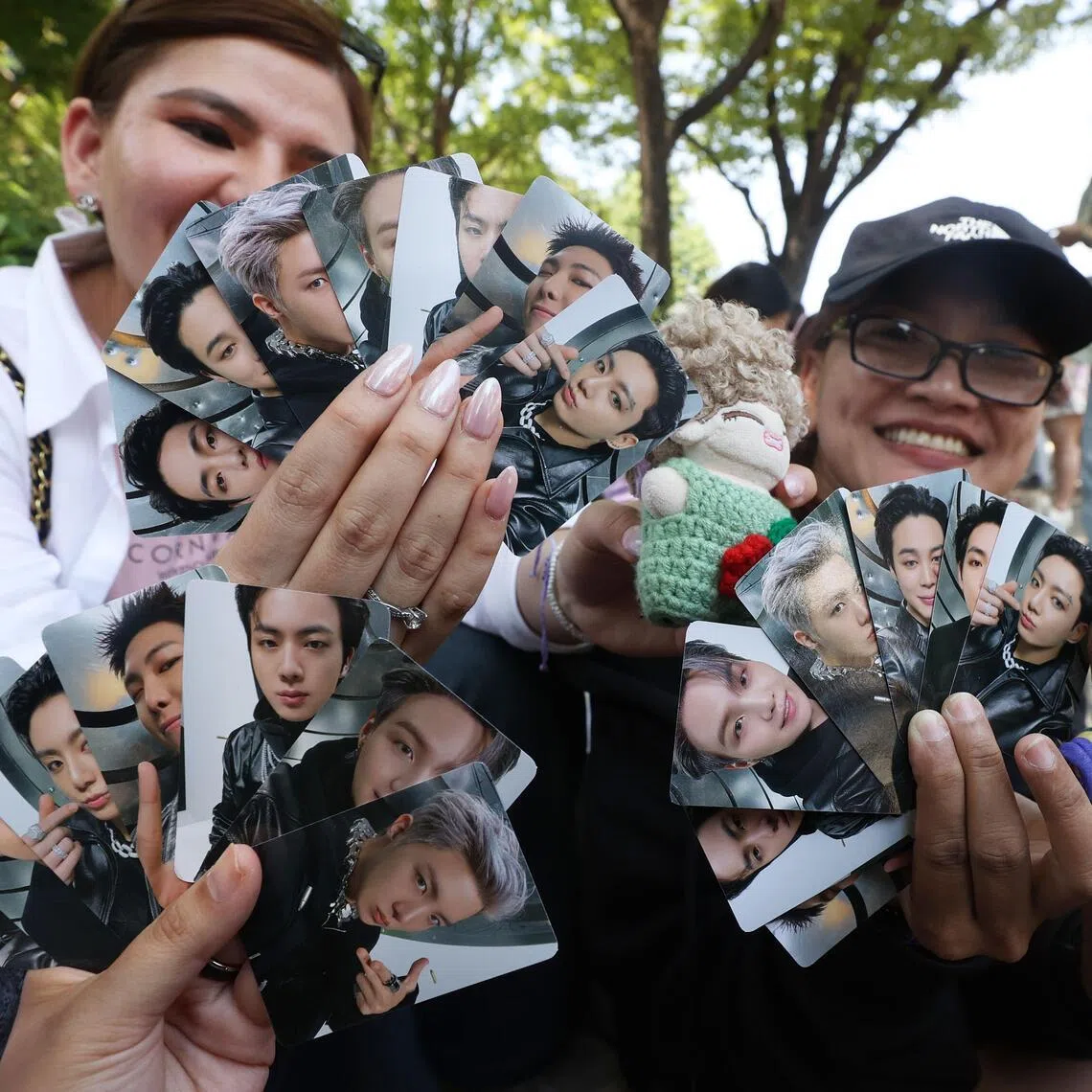 BTS' Army show off souvenirs at the 2024 BTS Festa, marking the septet's 10th anniversary, in South Korea on June 13, 2024.