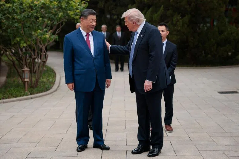US President Donald Trump (right) gestures to China’s President Xi Jinping as he leaves after a visit to Zhongnanhai Garden in Beijing, on May 15.