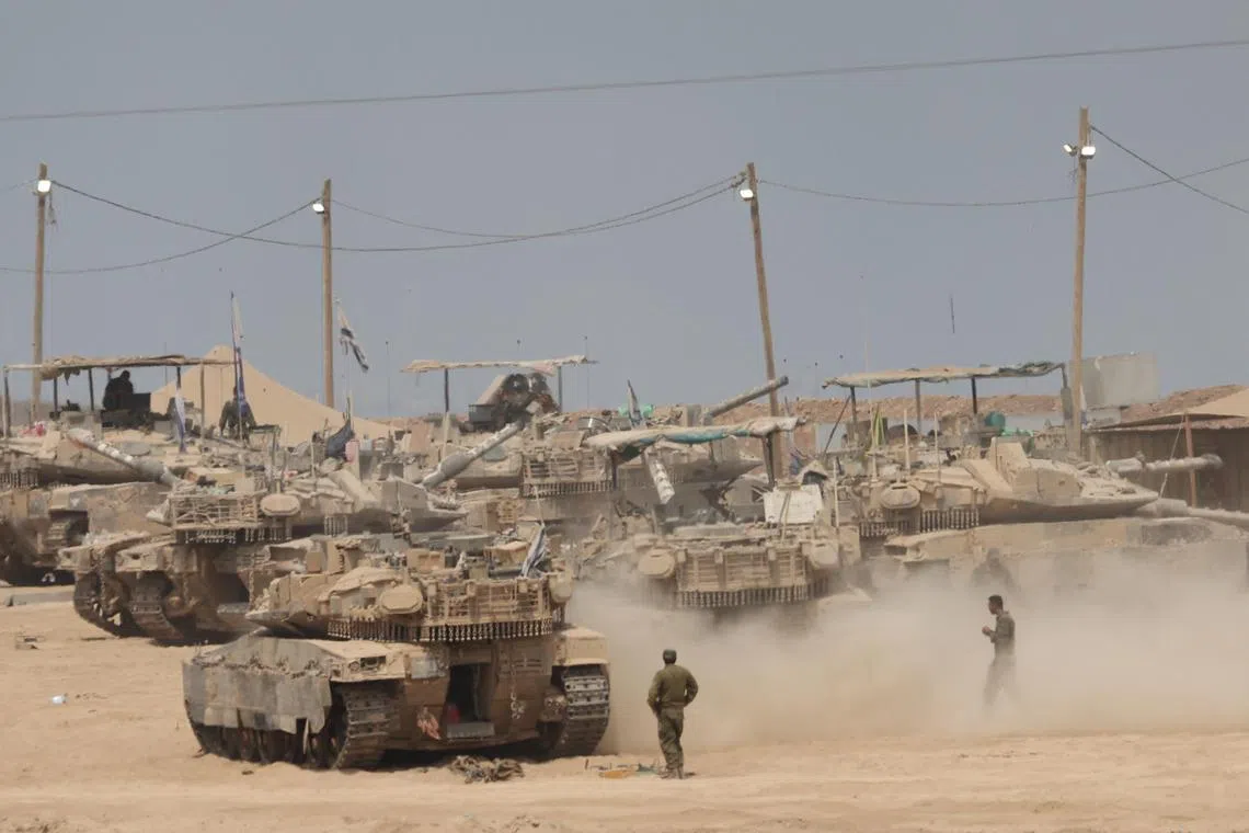 Israeli armoured vehicles are seen near the Gaza border in southern Israel on Aug 12, 2025.