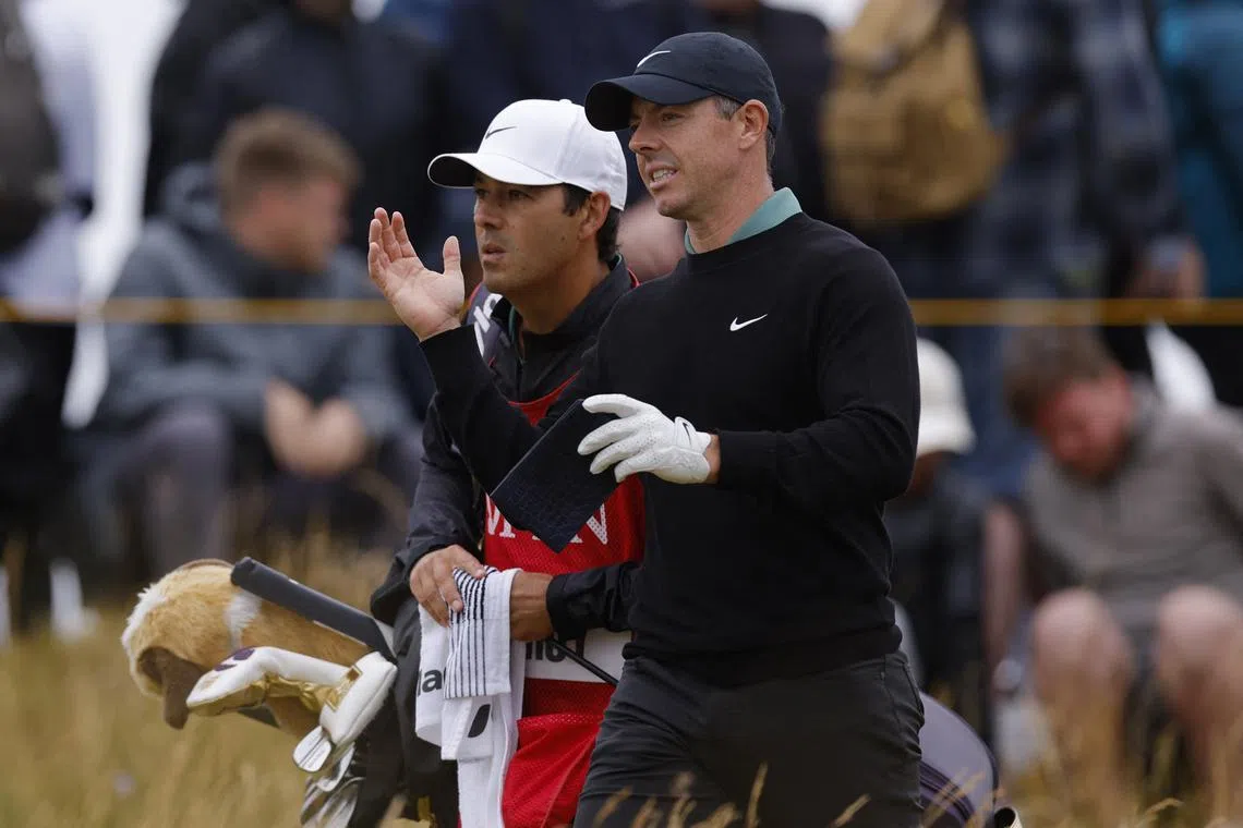 Golf - The 152nd Open Championship - Royal Troon Golf Club, Troon, Scotland, Britain - July 18, 2024 Northern Ireland's Rory McIlroy reacts as he speaks with his caddie after teeing off on the 9th hole during the first round REUTERS/Andrew Couldridge