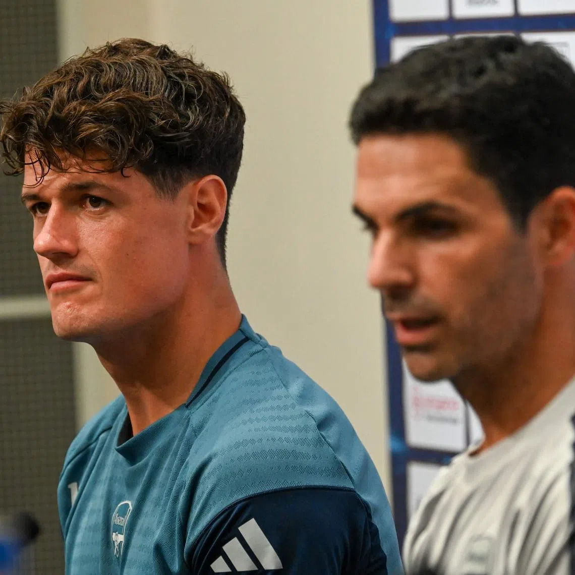 Arsenal’s Spanish manager Mikel Arteta (R) and Arsenal’s Christian Norgaard attend a pre-match press conference ahead of their football match against Newcastle United at the National Stadium in Singapore on July 25, 2025. (Photo by Roslan RAHMAN / AFP)