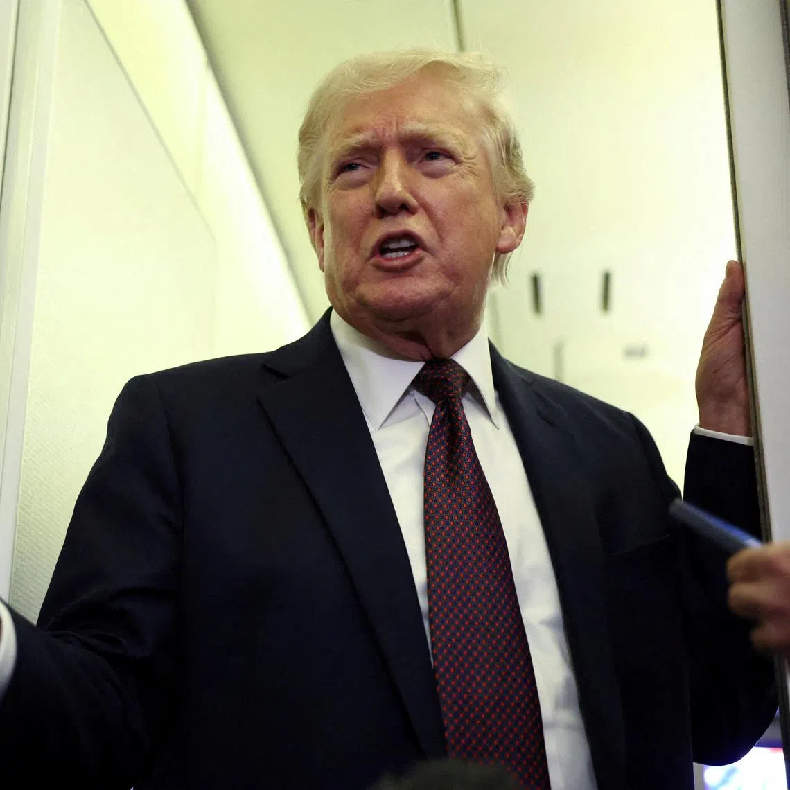 FILE PHOTO: U.S. President Donald Trump speaks to reporters aboard Air Force One on a flight back to Washington March 15, 2026. REUTERS/Kevin Lamarque/File Photo