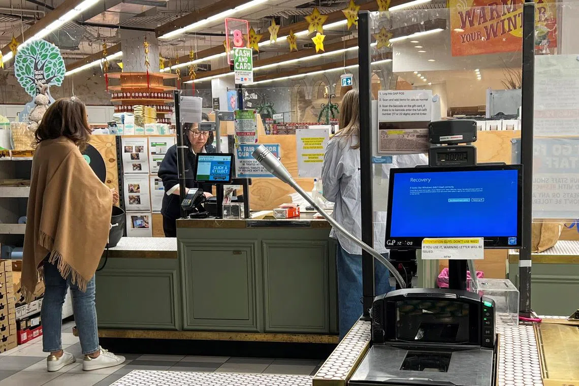 A cash register shows a blue screen at a grocery store affected by a cyber outage in Sydney, Australia July 19, 2024. REUTERS/Stella Qiu