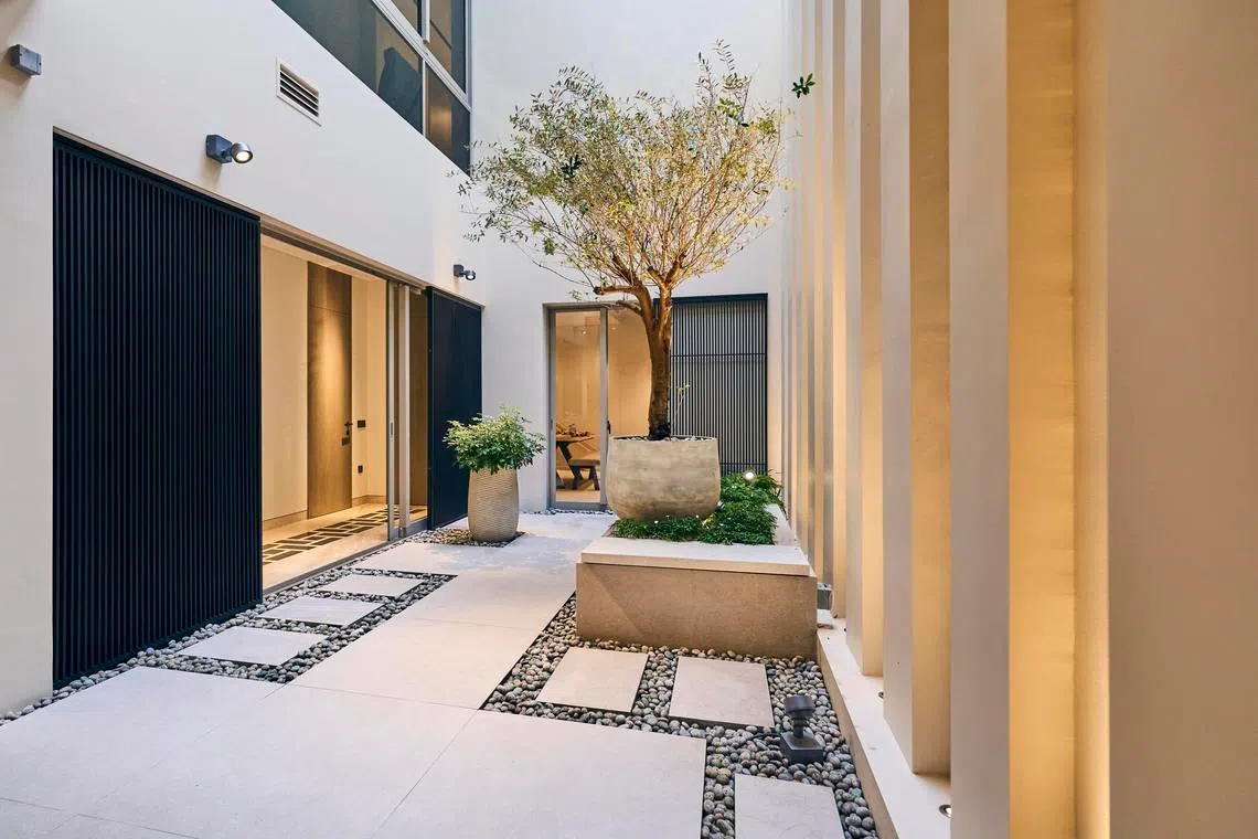 Vertical fins and uplighting create a sense of drama in the courtyard.