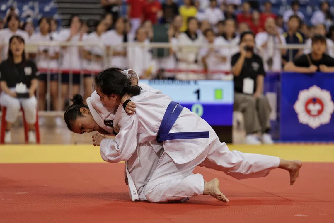 Hougang Secondary School?s Nur Syafira Shaharudin (left) flooring Nanyang Girls? School?s Chen Siyan to win the girls? 45kg final of the National School Games? C Division Judo Championships at OCBC Arena on July 18, 2024.