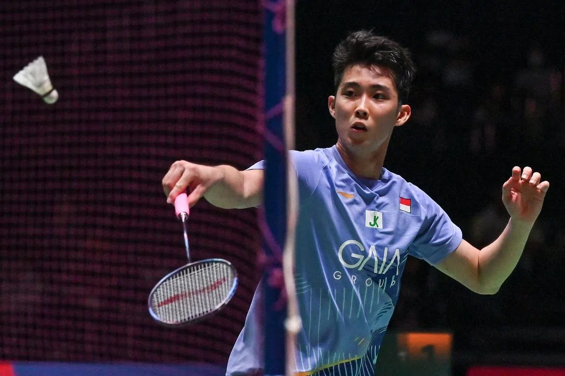 Loh Kean Yew of Singapore hits a return against Ng Tze Yong of Malaysia during their men's singles match on the second day of the Japan Open badminton tournament in Tokyo on July 26, 2023. (Photo by Richard A. Brooks / AFP)