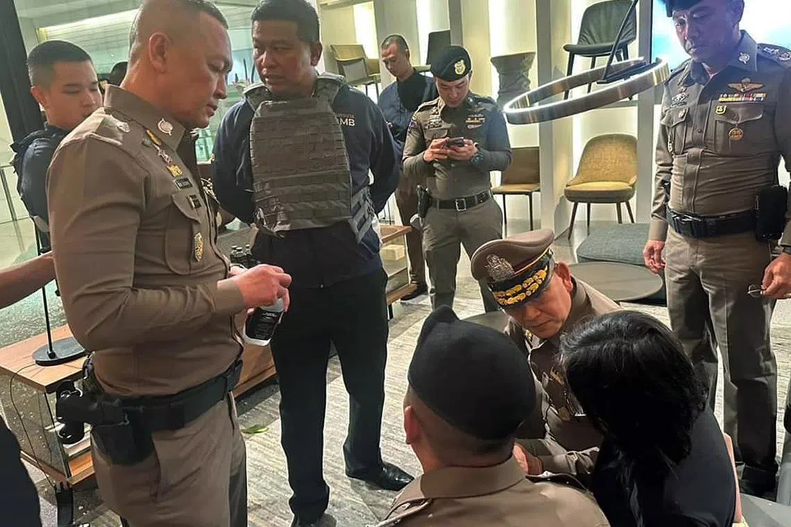 Thai police talking to the 14-year-old suspect after arresting him on Oct 3, 2023. 