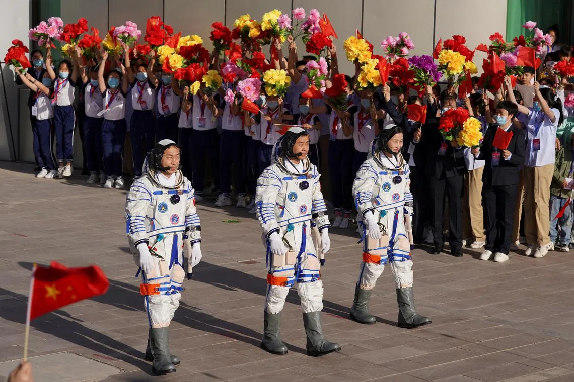 Chinese astronauts Chen Dong, Liu Yang and Cai Xuzhe attend a see-off ceremony before the launch of the Long March-2F carrier rocket, carrying the Shenzhou-14 spacecraft for a crewed mission to build China's space station, at Jiuquan Satellite Launch Center near Jiuquan, Gansu province, China June 5, 2022.  China Daily via REUTERS  ATTENTION EDITORS - THIS IMAGE WAS PROVIDED BY A THIRD PARTY. CHINA OUT.