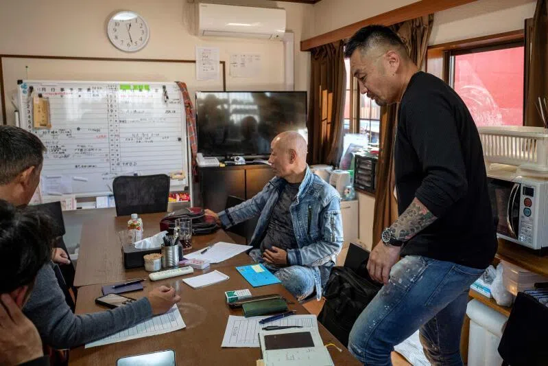 Former gangster Yoshiro Nishino (right) discussing management with residents of his group home for ex-offenders in Chiba Prefecture on Nov 7.