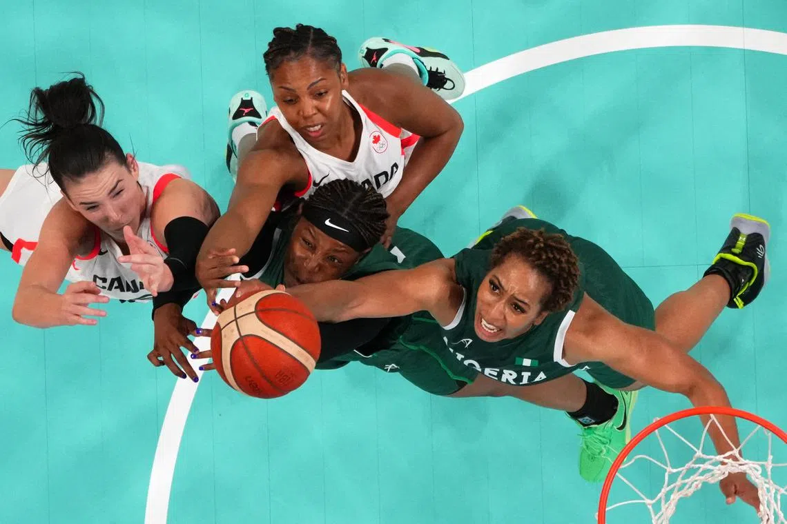 FILE PHOTO: Paris 2024 Olympics - Basketball - Women's Group Phase - Group B - Canada vs Nigeria - Lille, Pierre Mauroy Stadium, Villeneve-d'Ascq, France - August 04, 2024. Bridget Carleton of Canada and Nirra Fields of Canada in action against Amy Okonkwo of Nigeria and Pallas Kunaiyi-Akpanah of Nigeria REUTERS/Brian Snyder/File Photo