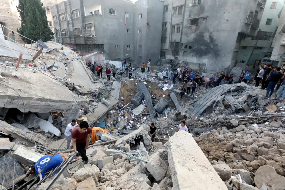 Israel levels Gaza district, missile hits Orthodox church | The Straits ...