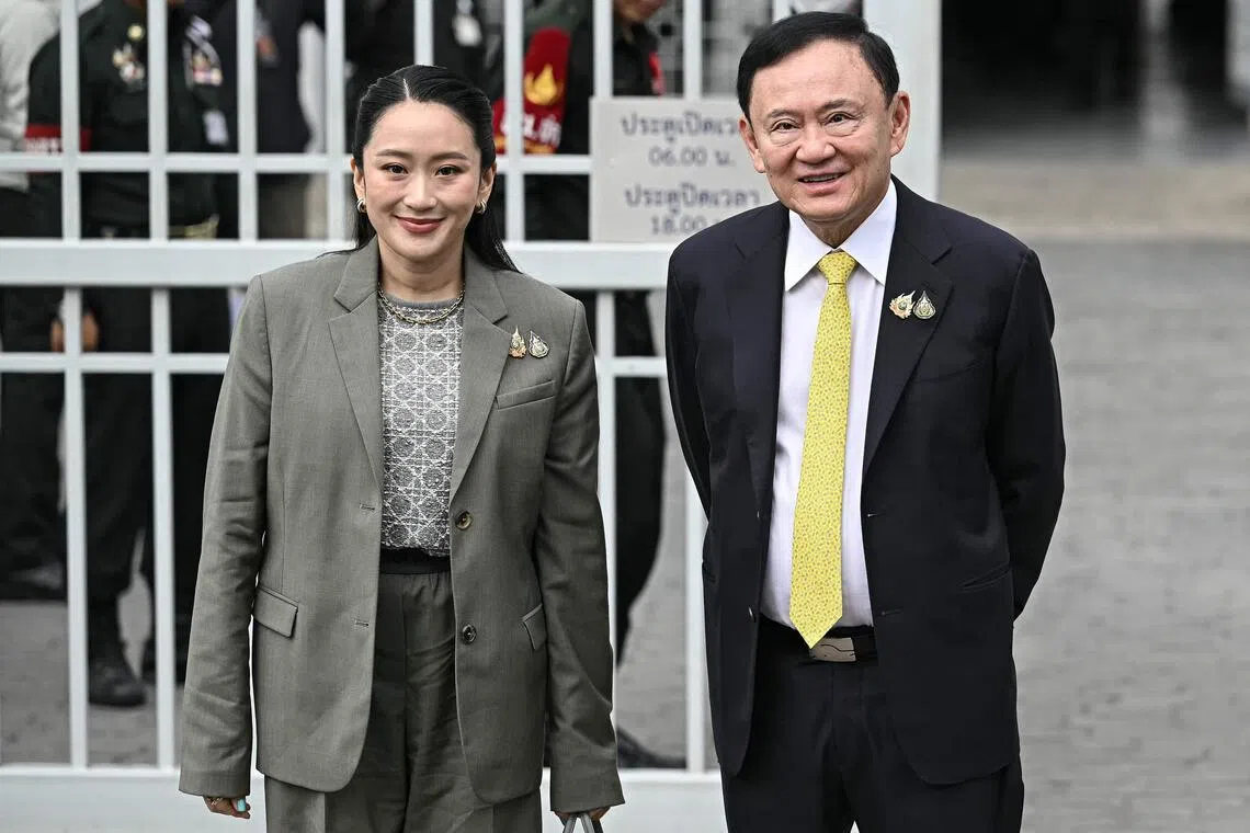 Former Thai prime minister Thaksin Shinawatra poses with his daughter Thailand's sacked prime minister Paetongtarn Shinawatra as they arrive at the Supreme Court in Bangkok on September 9, 2025, ahead of a ruling on whether he properly served a prison term in 2023. Thailand's recently removed prime minister Paetongtarn Shinawatra resigned on October 22, 2025 as leader of the party founded by her father, ex-premier Thaksin, signaling the potential end of the family's decades-long political dynasty. (Photo by Lillian SUWANRUMPHA / AFP)
