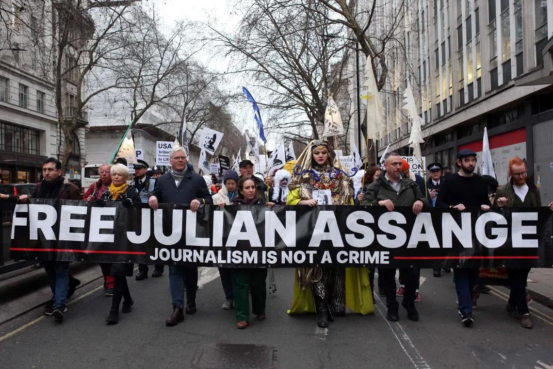 Supporters of WikiLeaks founder Julian Assange marching in London on Feb 11. Assange is battling extradition from Britain to the US.