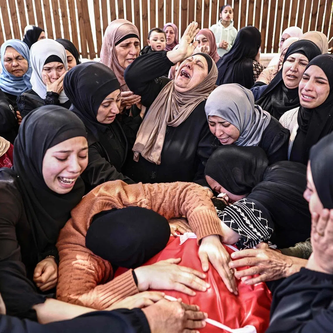 Relatives mourning the death of Jihad Marzouq Abu Naim during his funeral in Al-Mughayyir, east of Ramallah in the Israeli-occupied West Bank, on April 22, 2026. The Palestinian Authority said Israeli settler gunfire killed two Palestinians, including 14-year-old Aws Hamdi Al-Naasan and 32-year-old Jihad Marzouq Abu Naim, both from Al-Mughayyir,  in the central occupied West Bank.
