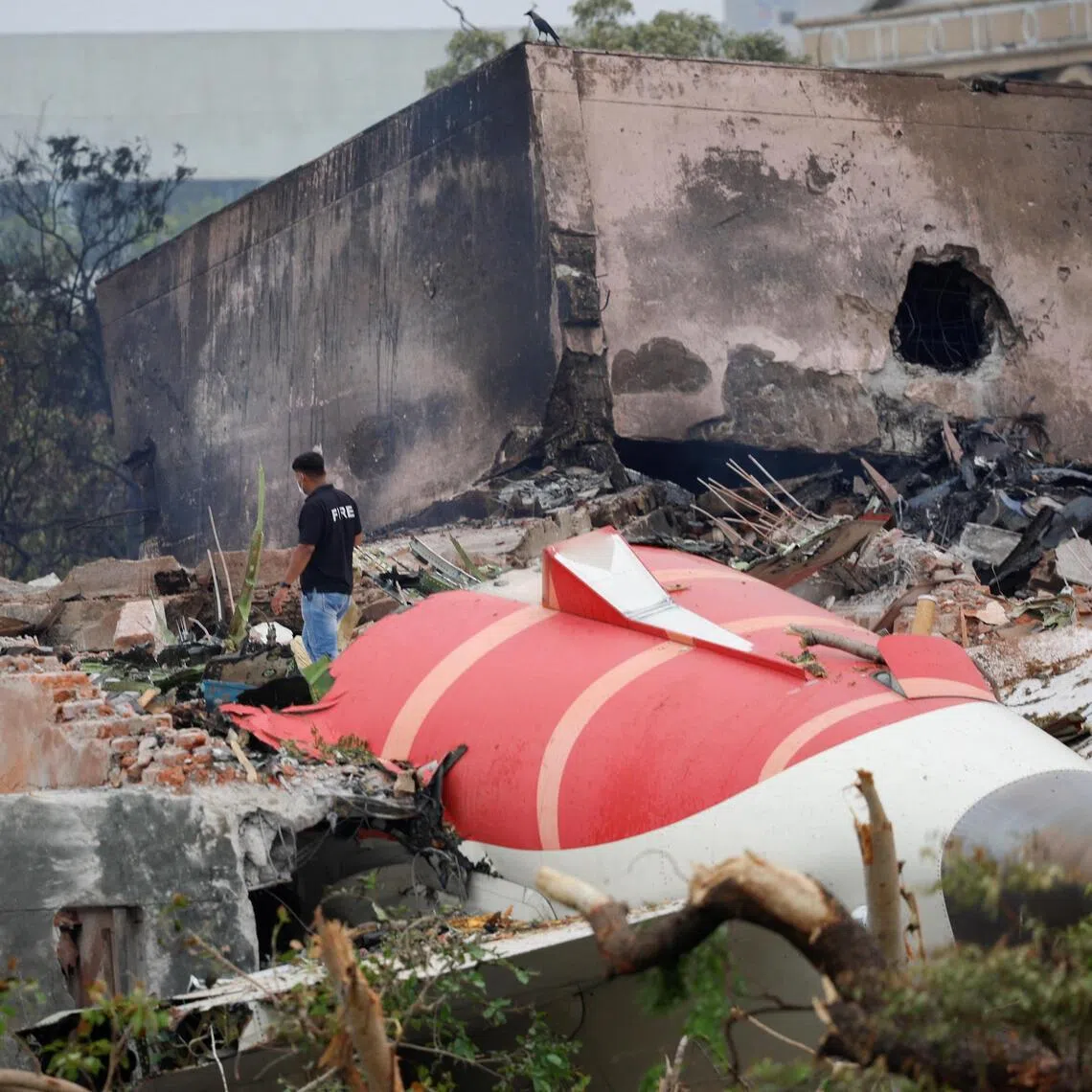 A fire offical stands next to the crashed Air India Boeing 787-8 Dreamliner aircraft, in Ahmedabad, India on June 13, 2025. 