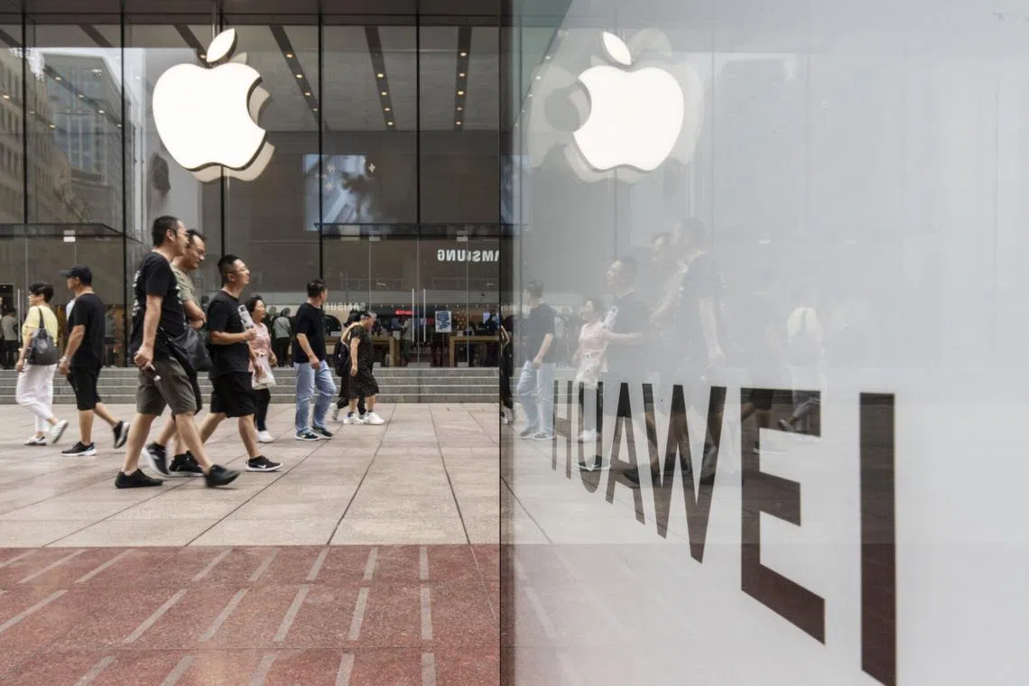 An advertisement for Huawei Technologies Co. across from an Apple Inc. store in Shanghai, China, on Tuesday, Sept. 10, 2024. Huawei announced the world's first commercial device with two folds, claiming leadership in mobile design just after Apple Inc. unveiled its latest iPhones. Photographer: Qilai Shen/Bloomberg