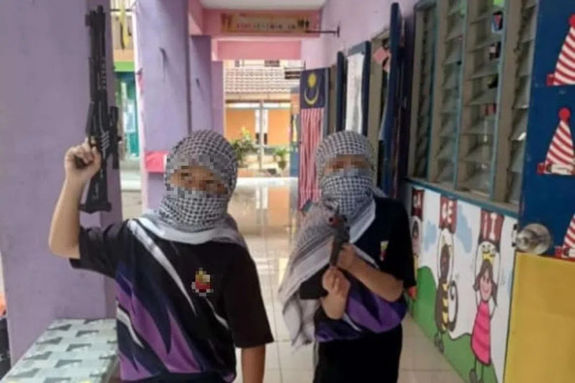 Children at an unidentified school bearing mock firearms during solidarity programmes with Palestine in Malaysia. PHOTO: KLSAYANG/X