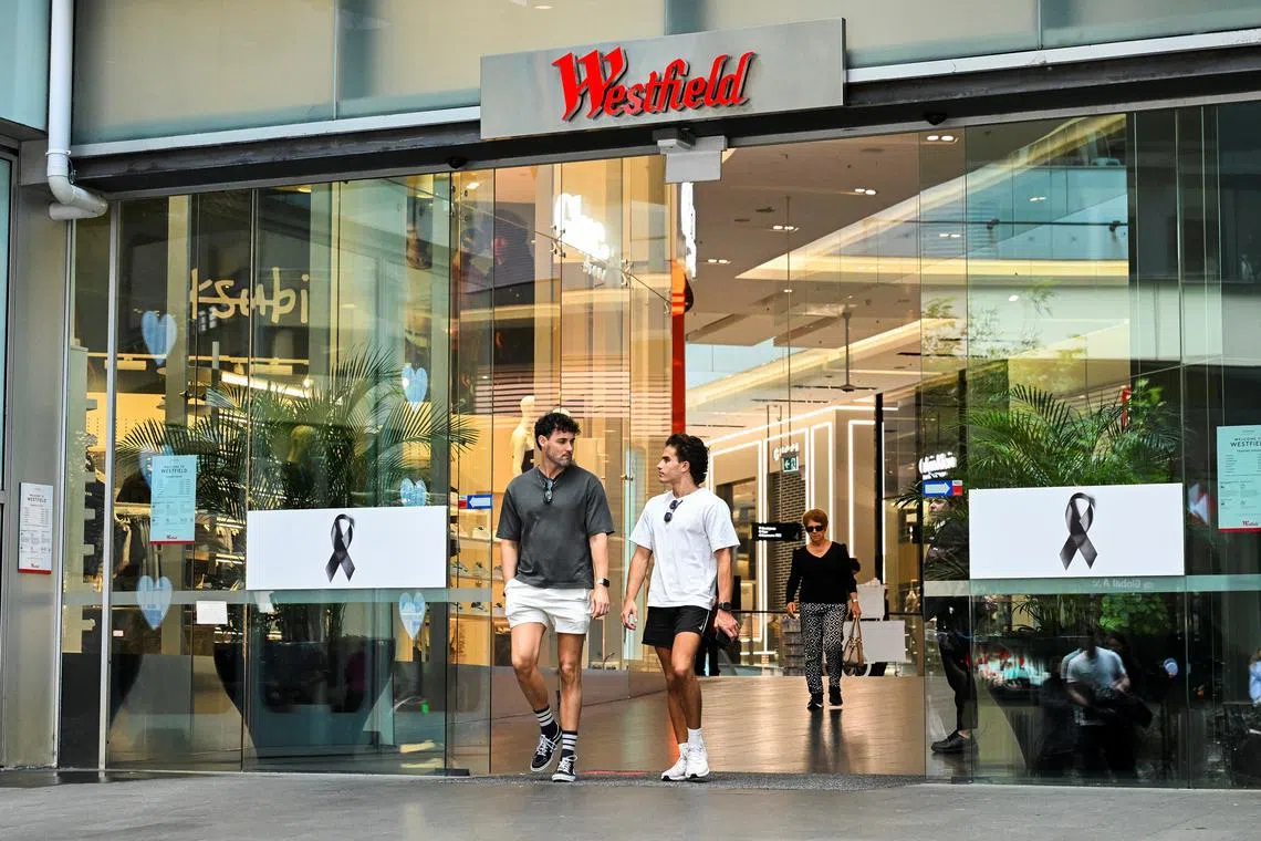 People walk out of the Westfield Bondi Junction shopping centre as it re-opens to the public for the first time after the stabbing attacks which killed several people at the shopping centre, in Sydney, Australia, April 18, 2024. REUTERS/Jaimi Joy