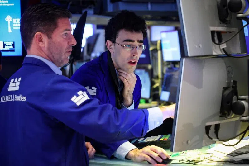 Traders work on the floor at the New York Stock Exchange in New York City, on April 13, 2026.