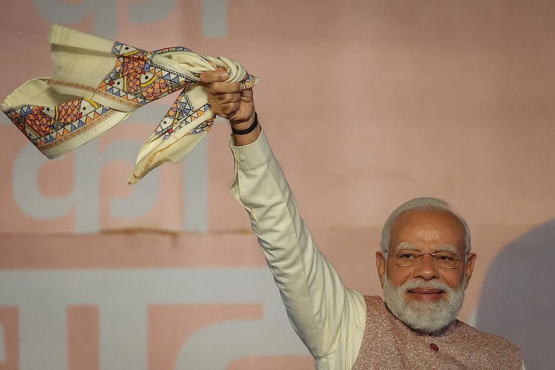 India's Prime Minister Narendra Modi waves as his Bharatiya Janata Party supporters celebrate the Bihar state assembly election results. 