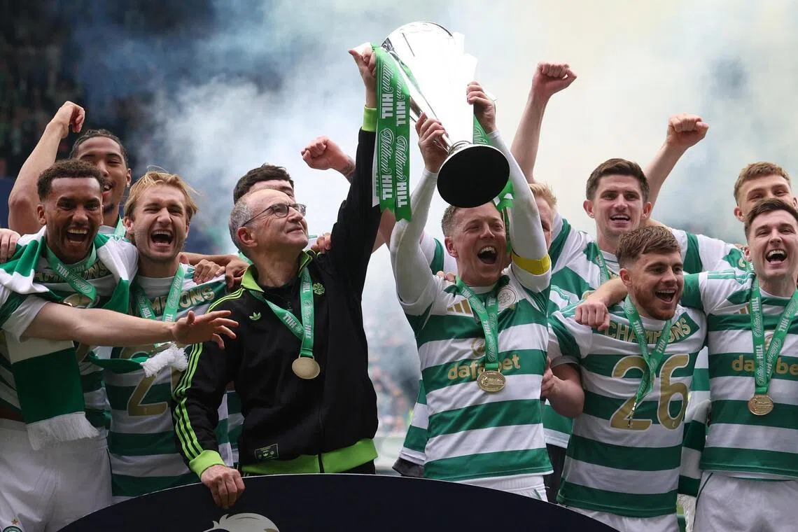 Celtic manager Martin O'Neill and captain Callum McGregor celebrate lifting the Scottish Premiership trophy after beating Heart of Midlothian at Celtic Park in  Glasgow on May 16, 2026.