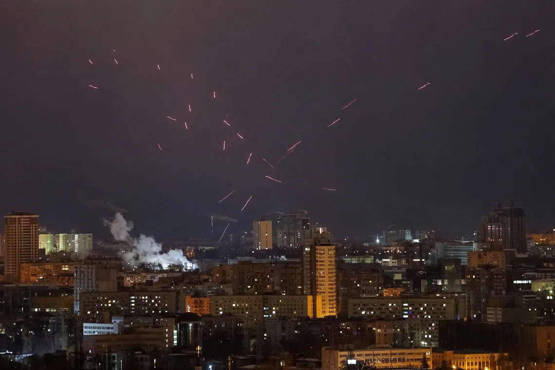 Tracers are seen in the night sky as Ukrainian servicemen fire at the drone during a Russian drone strike, amid Russia's attack on Ukraine, in Kyiv, Ukraine February 21, 2025. REUTERS/Gleb Garanich