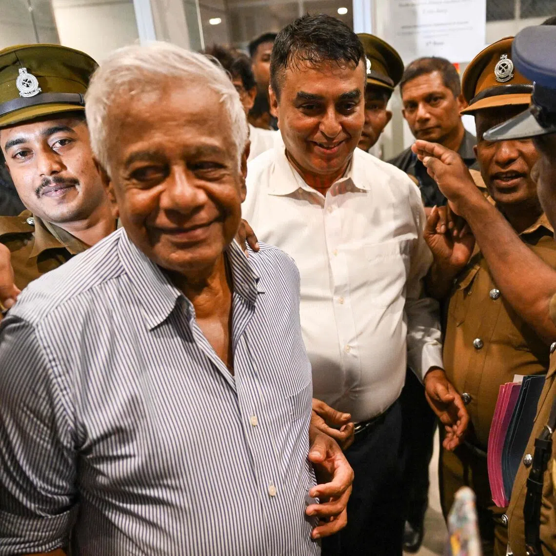 Former police chief Pujith Jayasundara (right) and former defence ministry secretary Hemasiri Fernando (left) are taken to prison after receiving death sentence, in Colombo on July 31.