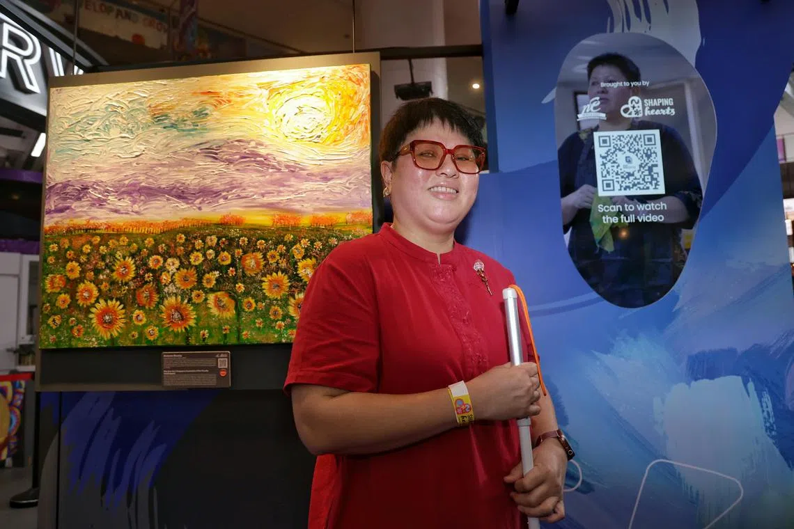 Profile of Ms Moy Saw Han, 50, who lost most of her vision in 2018 due to glaucoma, next to her artwork Autumn Beauty at Shaping Hearts 2024, Singapore's largest inclusive arts festival that brings together the exceptional talents of over 200 artists with disabilities, at Our Tampines Hub on Oct 19, 2024.