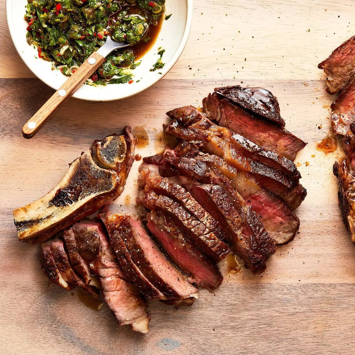 Seared bone-in rib-eye steaks.