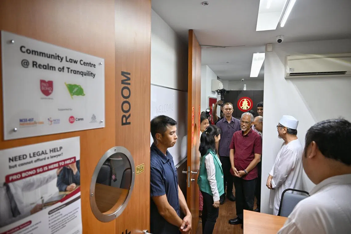 Minister for Social and Family Development Masagos Zulkifli (in red shirt) touring the new community legal centre on Jan 19.