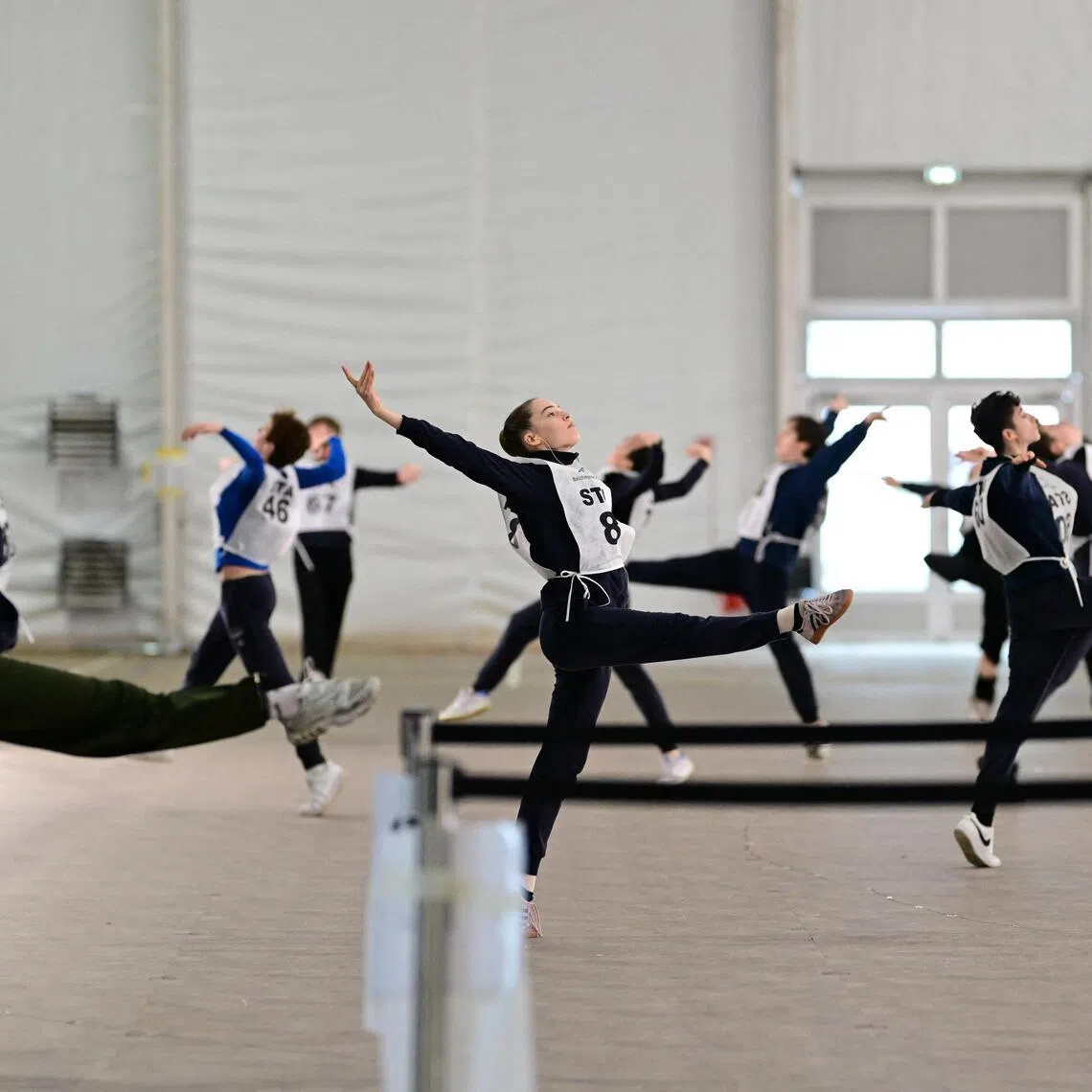 Volunteer dancers rehearse during preparations for the opening ceremony inside a temporary structure next to San Siro stadium.