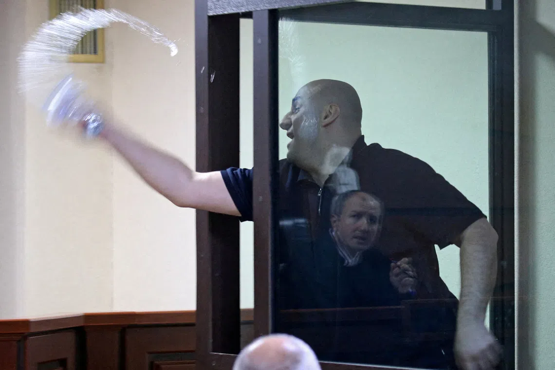 FILE PHOTO: Nika Melia, one of the leaders of the Coalition for Change opposition group, charged with failing to appear before the Georgian parliament's temporary investigative commission, splashes water towards a judge during a court hearing in Tbilisi, Georgia May 30, 2025. REUTERS/Irakli Gedenidze/Pool/File Photo