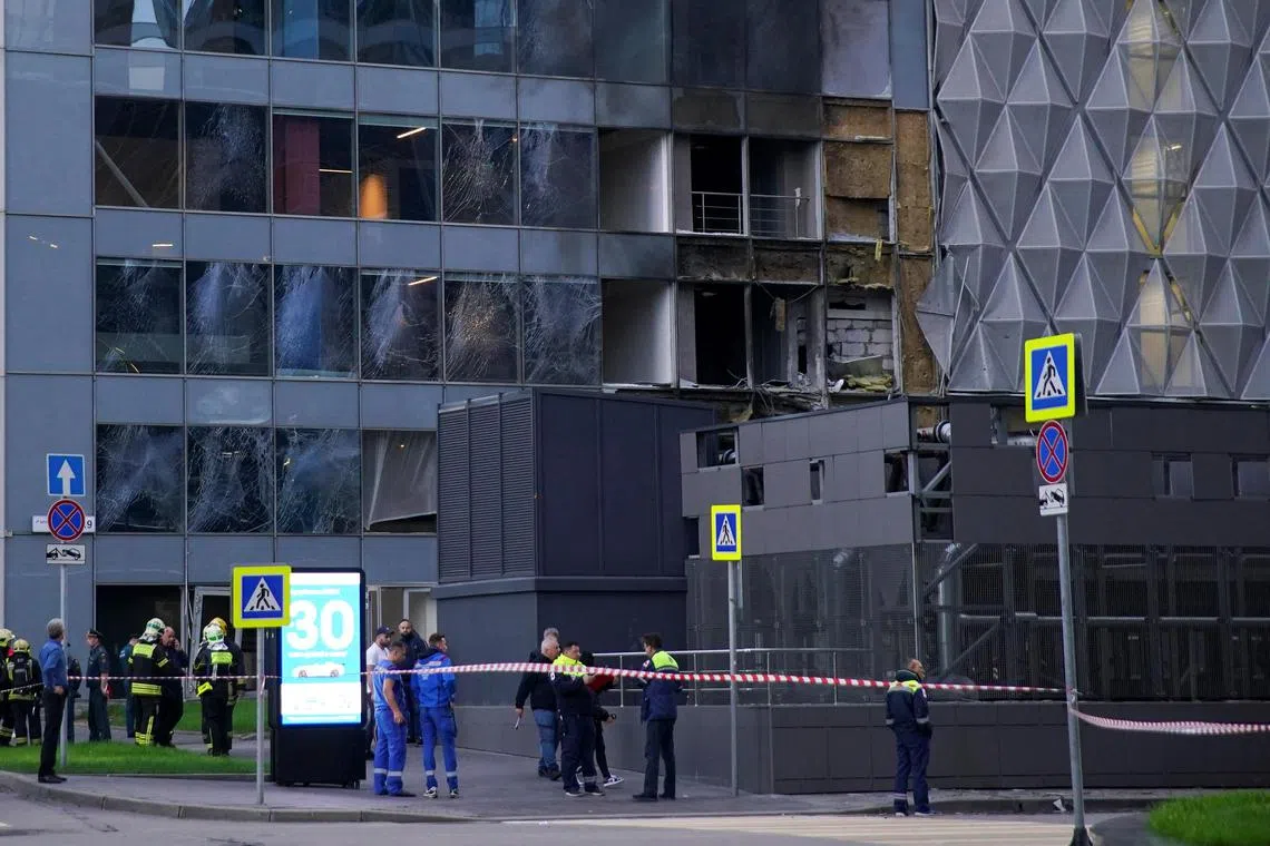 Emergency services members gather outside a damaged office building in Moscow following a reported Ukrainian drone attack on Sunday. 