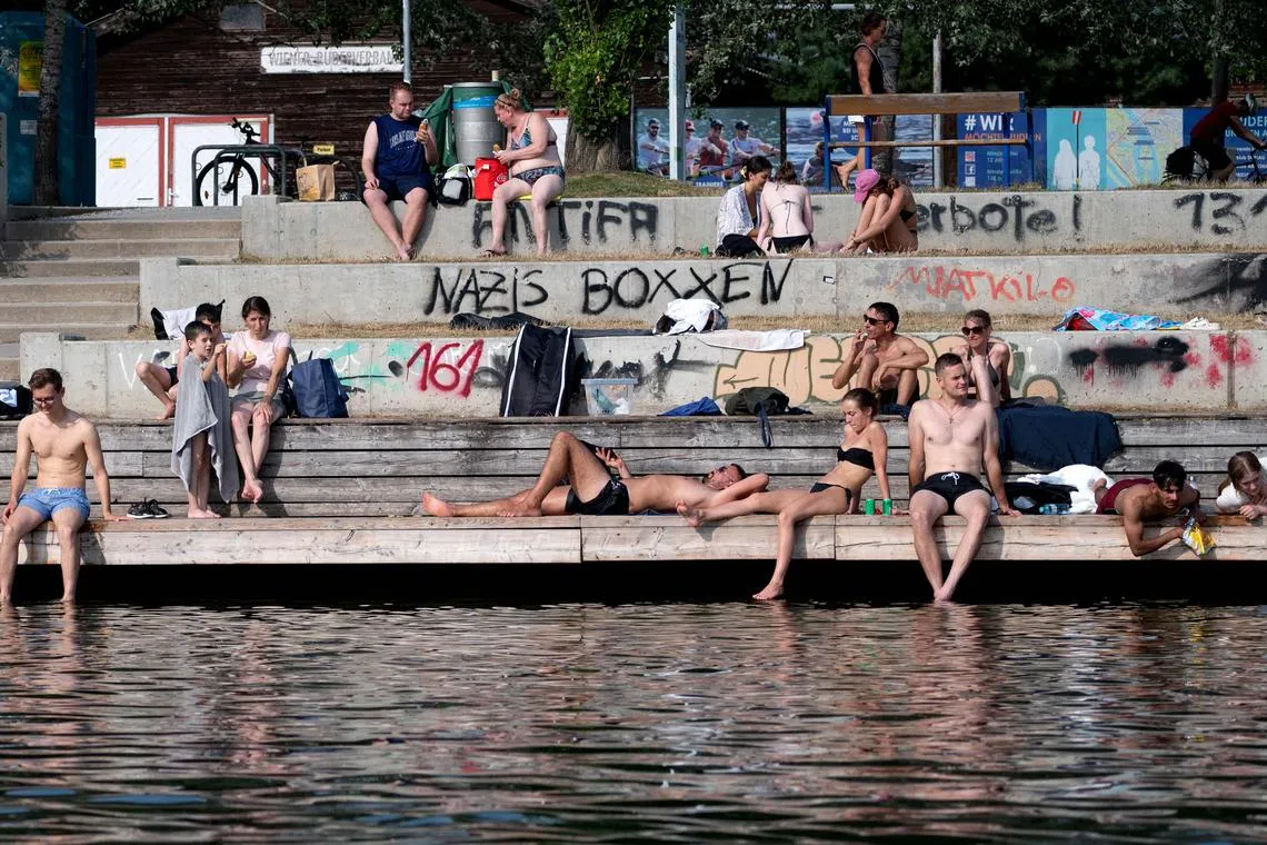 People enjoy the waters of the Danube river on a hot summer day in Vienna, Austria, on July 18.