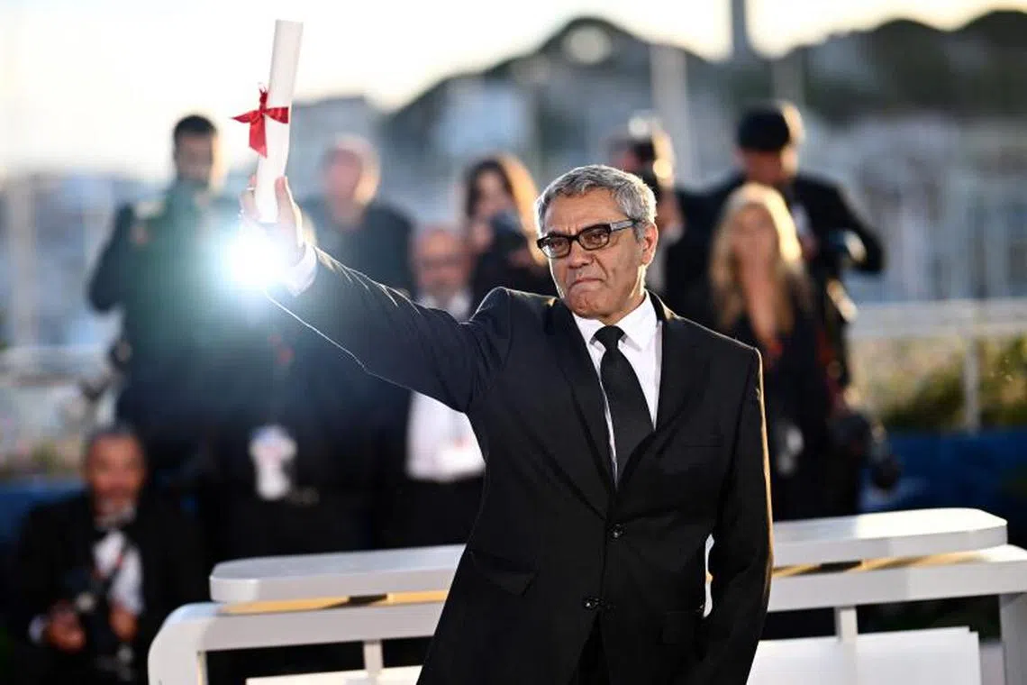 Iranian director and producer Mohammad Rasoulof poses for photos after he won the  Special Jury Prize for the film The Seed Of The Sacred Fig during the Closing Ceremony at the 77th edition of the Cannes Film Festival in France on May 25, 2024.