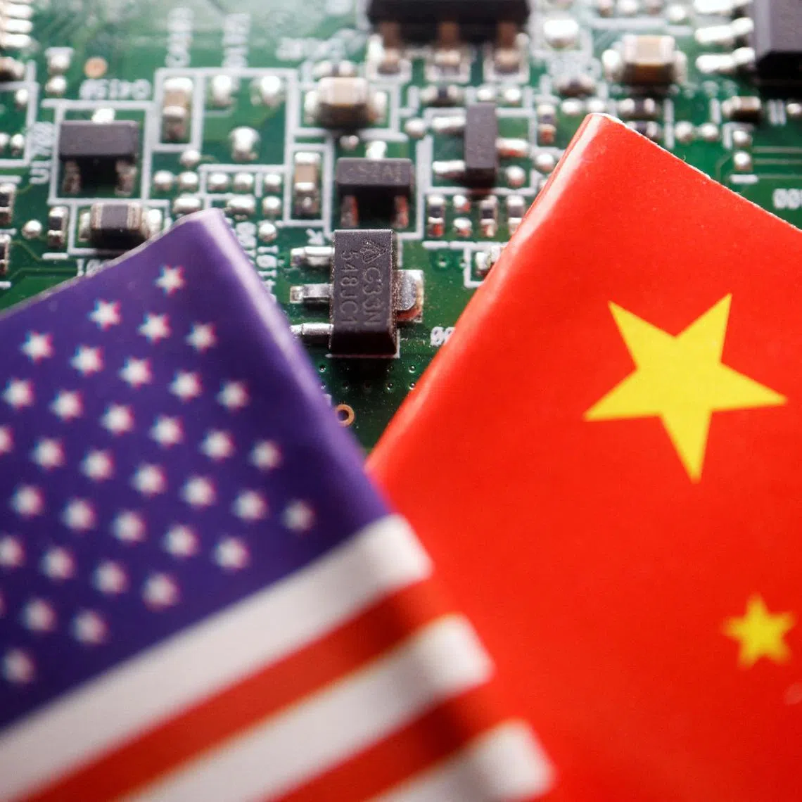 FILE PHOTO: Flags of China and U.S. are displayed on a printed circuit board with semiconductor chips, in this illustration picture taken February 17, 2023. REUTERS/Florence Lo/Illustration/File Photo
