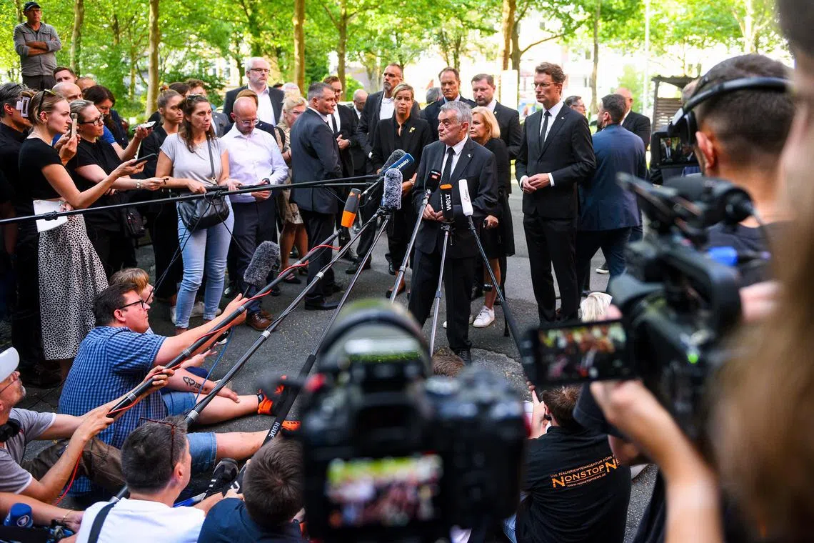 German Interior Minister Nancy Faeser, North Rhine-Westphalia state premier Hendrik Wuest and Interior Minister of the state of North Rhine-Westphalia Herbert Reul speak to media near the scene of the  attack in Solingen, Germany.