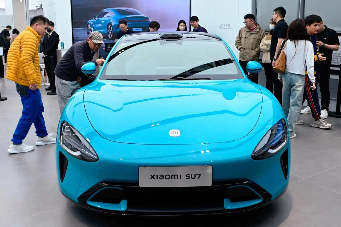 A Xiaomi SU7 electric car is displayed at a Xiaomi store in Beijing on March 26, 2024. (Photo by WANG Zhao / AFP)