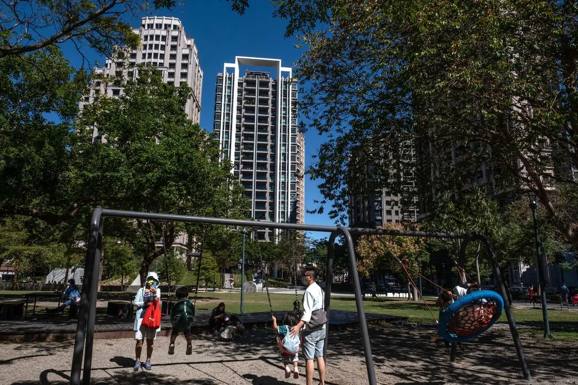 Residents at a park in front of residential buildings in Hsinchu, Taiwan, on Nov. 3, 2022. 