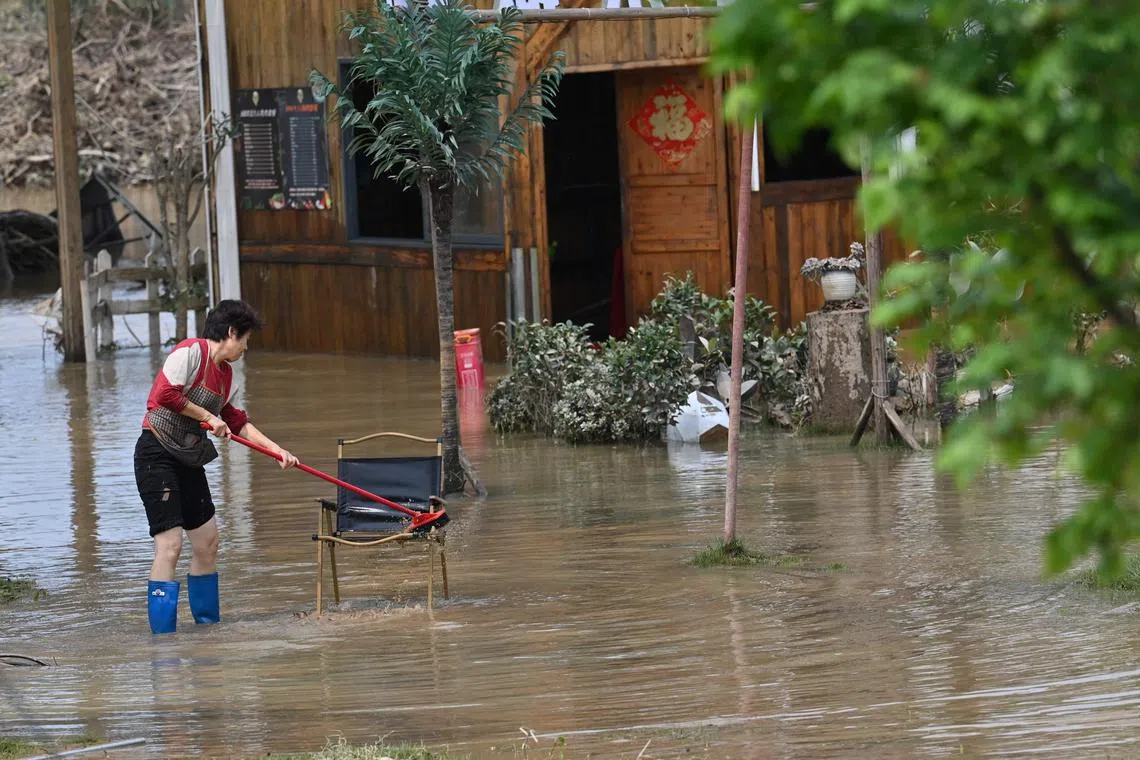 Residents waded through knee-deep water to salvage chairs and other belongings.