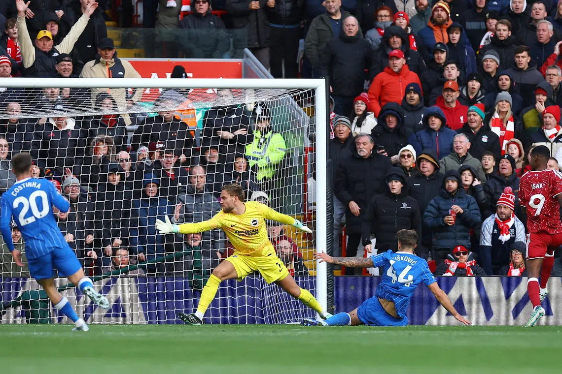 Liverpool’s Alexander Isak scores their second goal past Brighton and Hove Albion’s Bart Verbruggen.