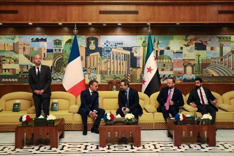 France’s President Emmanuel Macron (second left) speaks with Syria’s Foreign Minister Asaad al-Shaibani (centre right) during a bilateral meeting in Damascus.